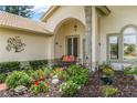 Welcoming front porch with colorful flowers and tasteful decor at 414 Long Cove Ct, Ormond Beach, FL 32174