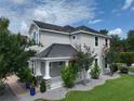 Charming home featuring a covered porch and manicured landscaping at 5095 Southlawn Ave, Orlando, FL 32811