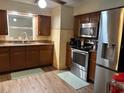 Well-equipped kitchen with stainless steel appliances, granite countertops, and dark wood cabinetry at 3439 Swindell Rd, Lakeland, FL 33810