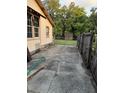 Long concrete driveway leads to a fenced backyard at 5418 Brownell St, Orlando, FL 32810