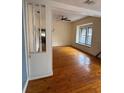 Open living room with wood floors and doorway view to the kitchen at 5418 Brownell St, Orlando, FL 32810