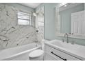 Updated bathroom featuring marble accent wall, shower over tub and modern vanity at 1304 E Myrtle St, Lakeland, FL 33801