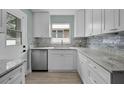 Modern kitchen featuring white cabinets, granite countertops, and stainless steel appliances at 1304 E Myrtle St, Lakeland, FL 33801