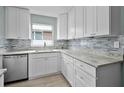 Modern kitchen featuring white cabinets, granite countertops, and stainless steel appliances at 1304 E Myrtle St, Lakeland, FL 33801