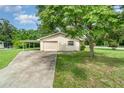 Exterior shot of home's garage and carport area with an extended driveway at 201 W New York Ave, Orange City, FL 32763