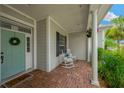 Inviting front porch with brick flooring, rocking chairs, and a beautifully decorated front door at 2973 Blackwater Creek Dr, Lakeland, FL 33810