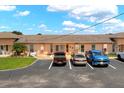 Charming condo building with well-maintained landscaping and convenient parking spaces for residents and guests at 4209 Club Cir, Lakeshore, FL 33854