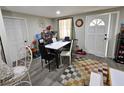 Bright dining area with a modern table set and decorative accents, adjacent to a white door at 3220 Avenue J Nw, Winter Haven, FL 33881