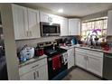 Modern kitchen equipped with stainless steel appliances, granite countertops, and white cabinetry at 3220 Avenue J Nw, Winter Haven, FL 33881