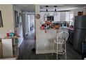 Open kitchen featuring white cabinets, stainless steel appliances, and a breakfast bar area at 3220 Avenue J Nw, Winter Haven, FL 33881