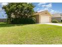 Charming single-story home featuring a manicured lawn, mature landscaping, and a two-car garage at 3243 Winchester Estates Cir, Lakeland, FL 33810