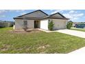 Attractive home with a well-maintained lawn, inviting entrance, and an attached two-car garage at 1741 Canaan Loop, Dundee, FL 33838