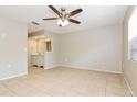 Spacious primary bedroom with tile floors, ceiling fan, and an attached vanity area at 248 Lake Thomas Dr, Winter Haven, FL 33880