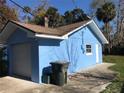 Exterior view of the home showing the garage and the light blue exterior paint at 1257 Dal Maso Dr, Daytona Beach, FL 32117
