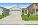 Inviting single-Gathering home boasting a two-car garage and manicured front lawn at 1335 Berry Ln, Davenport, FL 33837