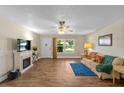 Bright living room with wood floors, decorative fireplace, and comfortable furnishings at 2825 Woodcrest Ln, Lakeland, FL 33805