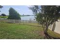 Landscaped backyard with a well-maintained fence and serene lake views at 2528 Ladoga Dr, Lakeland, FL 33805