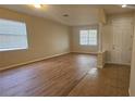 Spacious living room with beautiful wood-look flooring and large windows offering ample natural light at 2528 Ladoga Dr, Lakeland, FL 33805