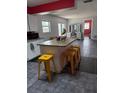 Bright kitchen with island, granite countertops, and yellow stools, great for entertaining at 3435 Swindell Rd, Lakeland, FL 33810