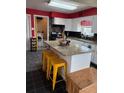 Bright kitchen featuring an island with granite countertops and stylish yellow stools at 3435 Swindell Rd, Lakeland, FL 33810