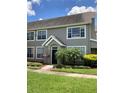 Well-maintained townhome featuring manicured landscaping, a covered entrance, and a welcoming facade at 9053 Lee Vista Blvd # 1405, Orlando, FL 32829