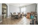 Bright dining room features a chandelier, tile flooring, and a wooden table with upholstered chairs at 4931 Jetton Dr, Orlando, FL 32837