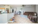 Inviting living room with tile floors, a plush rug, and comfortable leather seating at 4931 Jetton Dr, Orlando, FL 32837
