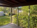 A screened in porch is shown with trees in the background at 1629 Lindsey Ter, Deltona, FL 32725