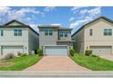 Modern two-story home features a brick driveway and a gray color scheme at 9349 Mira Valle Ln, Winter Garden, FL 34787