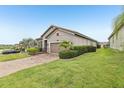 Well-kept home featuring a decorative driveway and lush green lawn at 4235 Prima Lago Dr, Lakeland, FL 33810