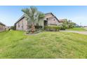 Landscaped front yard and green lawn enhance the curb appeal of this home at 4235 Prima Lago Dr, Lakeland, FL 33810