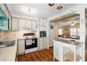 Cozy kitchen featuring vintage cabinetry, modern appliances, and plenty of counter space, perfect for cooking and entertaining at 932 Cassandra Ln, Lakeland, FL 33809