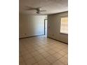 Spacious living room featuring neutral wall colors, tile flooring, and a bright window for natural light at 2505 W Parker St, Lakeland, FL 33815