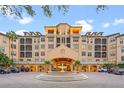 A grand building exterior with a water feature, arched entryway, and balconies at 504 Mirasol Cir # 102, Kissimmee, FL 34747