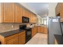 Bright kitchen featuring modern appliances, wood cabinetry, and ample counter space at 504 Mirasol Cir # 102, Kissimmee, FL 34747