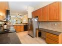 Well-equipped kitchen with stainless steel appliances and abundant wood cabinets at 504 Mirasol Cir # 102, Kissimmee, FL 34747