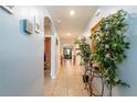 Long hallway with tiled floors, decor, leading to the living area, creating an open and inviting space at 5934 Shingle Creek Rd, Lakeland, FL 33811