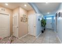 Inviting hallway with gray tiled floors, light blue walls, and white doors providing a bright and spacious feel at 5934 Shingle Creek Rd, Lakeland, FL 33811