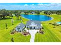 Breathtaking aerial view of a luxury estate with manicured lawns and a picturesque lake backdrop at 12902 Sw 138Th Loop, Dunnellon, FL 34432