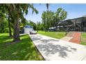 Long driveway leads to detached garage, workshop, and screened-in pool at 3229 Gardner Oaks Ln, Lakeland, FL 33810