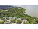 A stunning aerial view of the homes, lush greenery, and waterfront offering serene living at 297 Beacon Pointe Dr, Ocoee, FL 34761