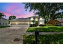 Charming home with a three-car garage, manicured lawn, and mature trees in a well-kept neighborhood at 297 Beacon Pointe Dr, Ocoee, FL 34761