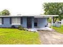 A cozy single-Gathering house featuring a covered carport and a neat, landscaped front yard at 5 Moonlight Ln, Winter Haven, FL 33884
