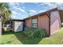 Home exterior with a shed, complemented by verdant foliage, adding a touch of nature at 89 Fremont Ave # 504, Daytona Beach, FL 32114