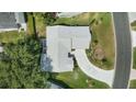 Aerial shot of home featuring a well manicured roof, lawn, and driveway at 508 Alcazar Ct, Lady Lake, FL 32159