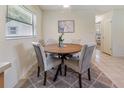Cozy dining area with round table, comfortable upholstered chairs, and natural light at 13449 Ashley Ct, Grand Island, FL 32735