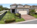 Attractive house featuring brick driveway, fenced yard, and a two-car garage at 16324 Brisk Breeze Aly, Winter Garden, FL 34787