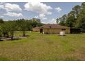 Spacious backyard with lush greenery and trees, perfect for outdoor enjoyment at 21590 Sw 84Th Loop, Dunnellon, FL 34431