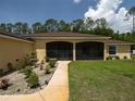Charming walkway leading up to the porch, accompanied by a landscaped garden at 21590 Sw 84Th Loop, Dunnellon, FL 34431