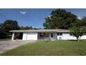 Charming single story home with a two car garage and a well maintained lawn at 1818 Fredricksburg Ave, Lakeland, FL 33803